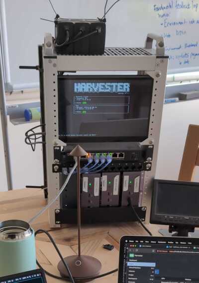 a 10 inch mini rack of computers with a screen showing a command line
&ldquo;Harvester version 1.7.1&rdquo; logo