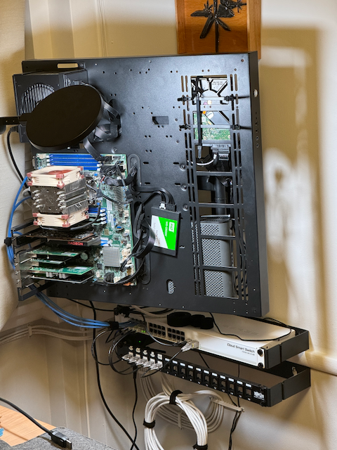 photograph of john's server rack with the webserver labeled with a red x and a 'you are here!' sign